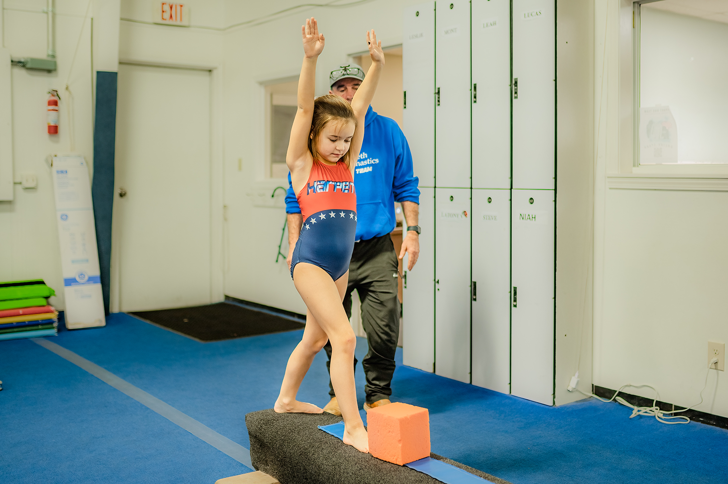 A Harpeth Gymnastics GymStar Team member receives focused instruction on the beam.