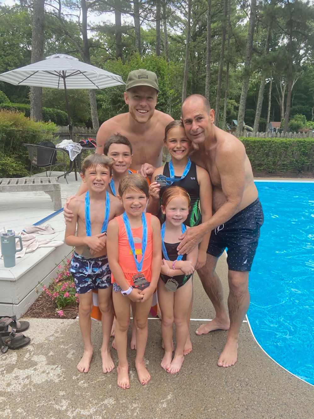 Coach Scott and family at the Webster Family Pool. All Coach Scott's grandchildren have completed swim lessons and received their medals.